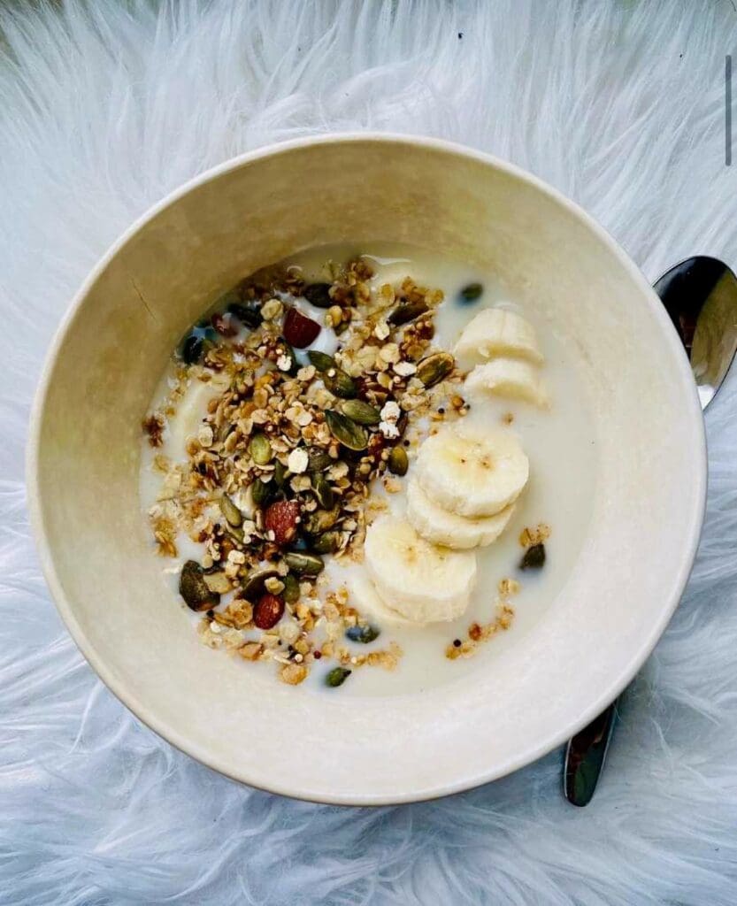 Bowl filled with granola with seeds and honey